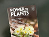 Color Photograph of the Power of Plants Magazine, from England's NIMH, on a green background.